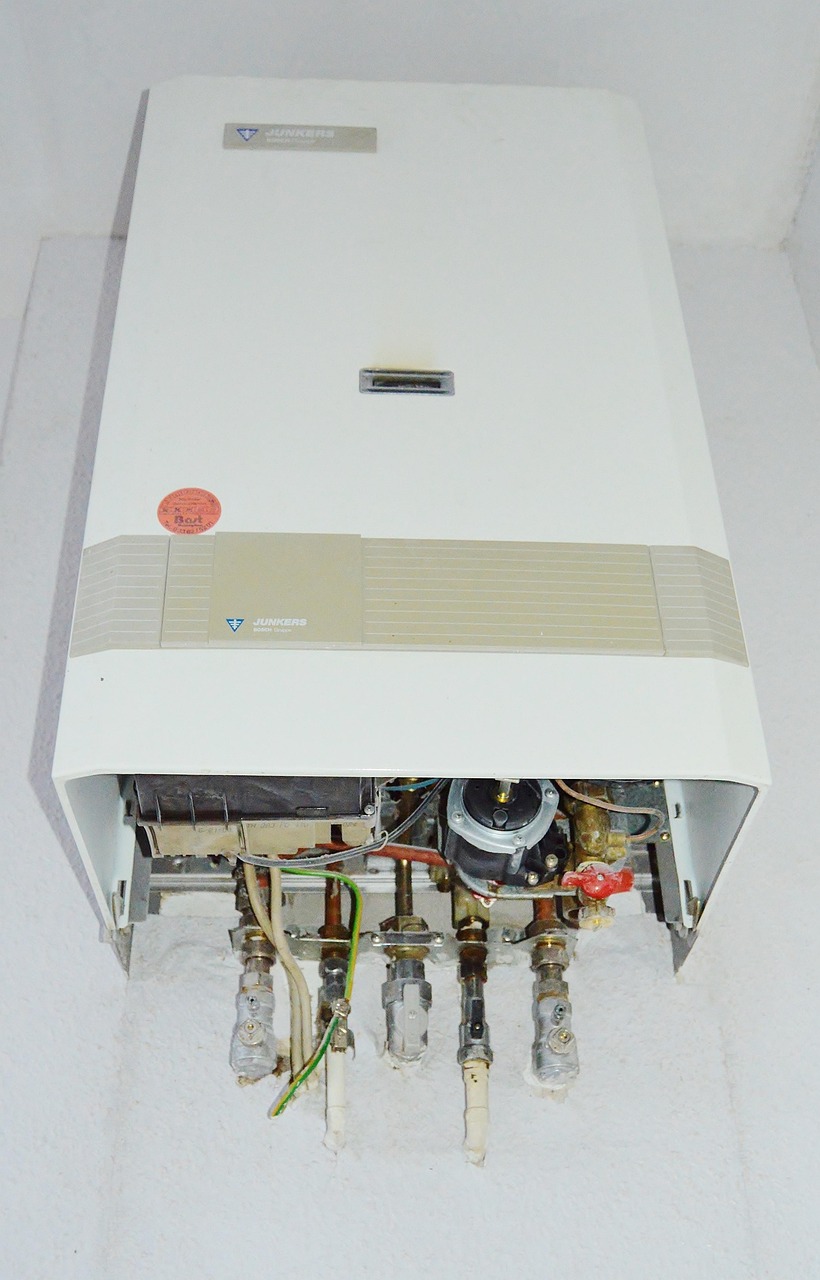 Wall-mounted gas water heating unit with exposed pipe connections