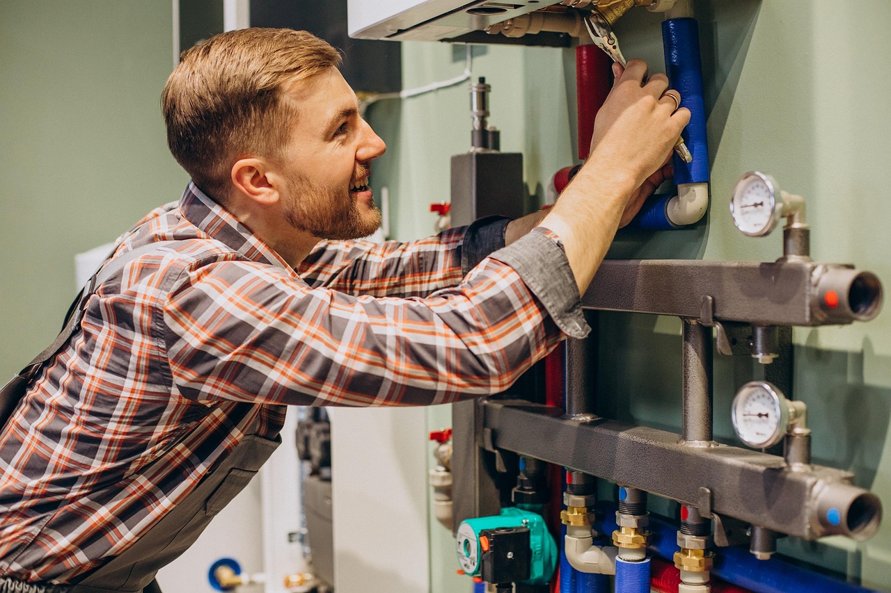 Technician working on a heating system manifold